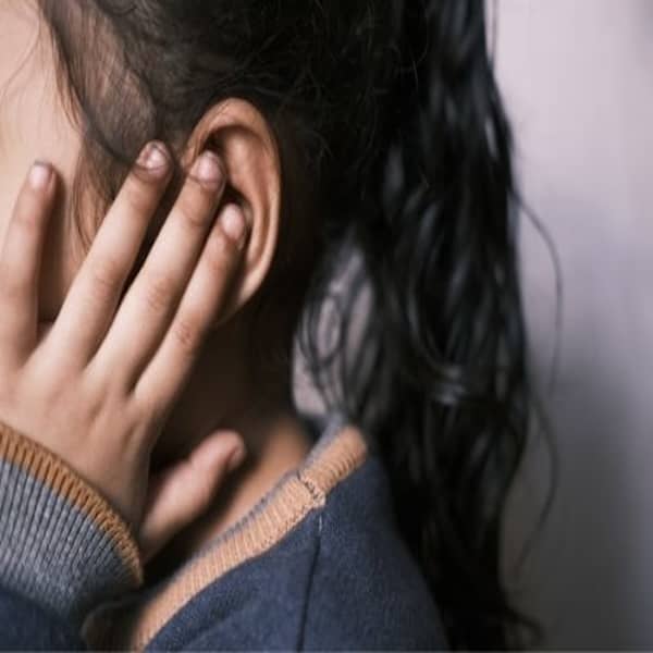 child touching ear