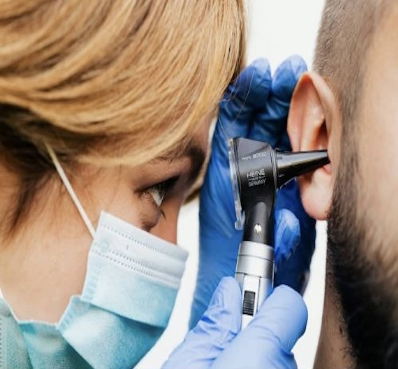 audiologist checking ear